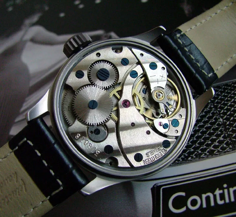 Mechanical watch movement seen through an open caseback