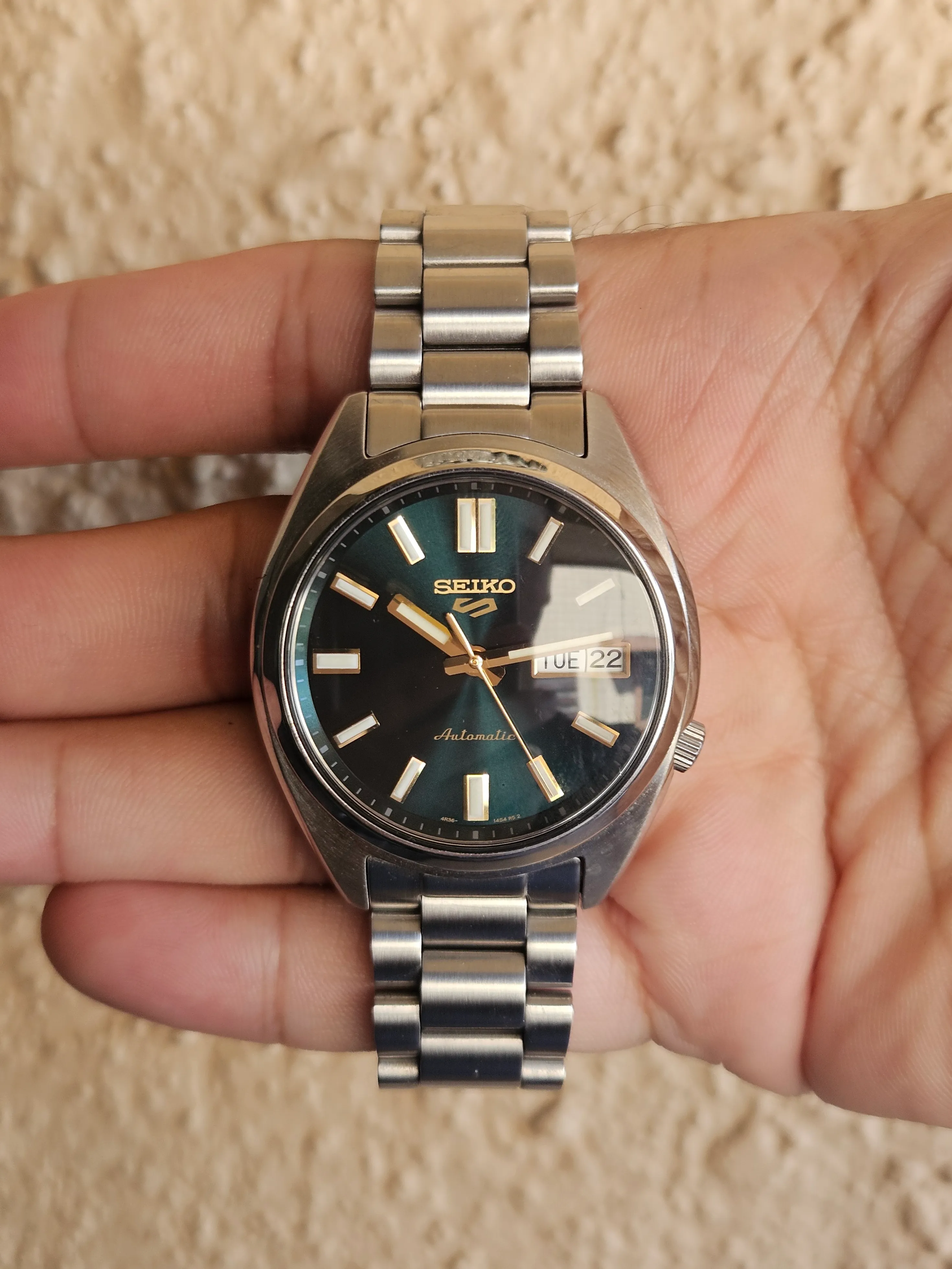 Seiko SRPL57K1 dial in brighter light, showing its emerald-green sunburst finish